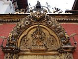 Kathmandu Bhaktapur 04-2 Bhaktapur Durbar Square Golden Gate Torana With Garuda And Taleju Bhawani A garuda tops the torana, disposing of a number of serpents, at the Golden Gate in Bhaktapur�s Durbar Square. The four-headed and 10-armed figure of the goddess Taleju Bhawani is directly above the door.